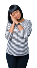 Beautiful young african american woman wearing stripes sweater over isolated background sleeping tired dreaming and posing with hands together while smiling with closed eyes.