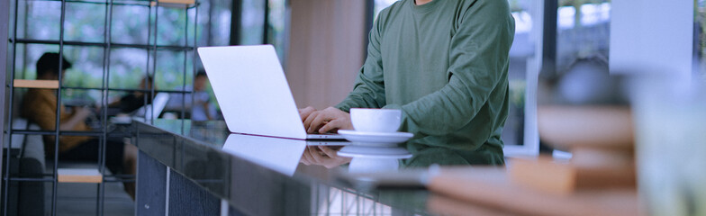 Young businessman's hands typing on laptop