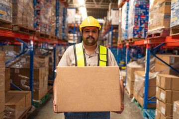 Male warehouse employee worker enjoy working and holding box in warehouse, Logistic industry...
