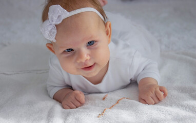 The sacrament of baptism of a child. The child is holding a cross.