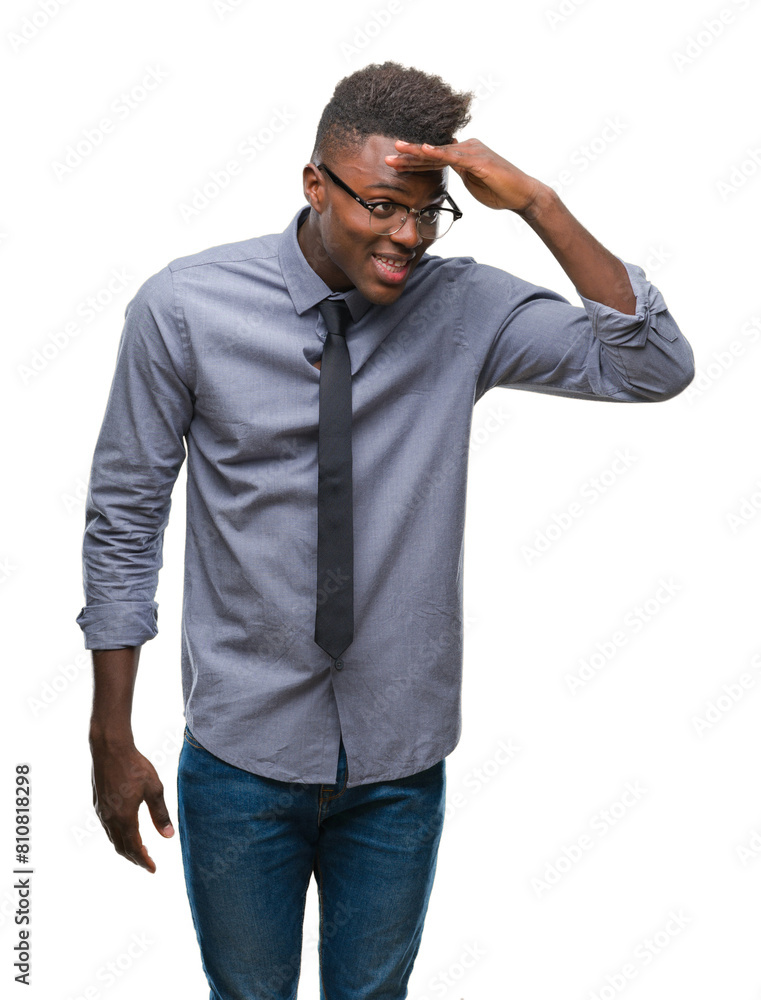 Canvas Prints Young african american business man over isolated background very happy and smiling looking far away with hand over head. Searching concept.