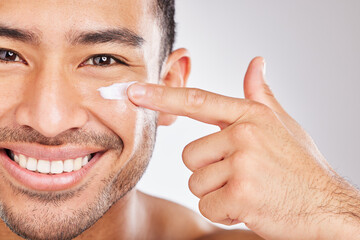 Asian man, portrait or face cream with smile or beauty in studio with antiaging cosmetics, glow and...