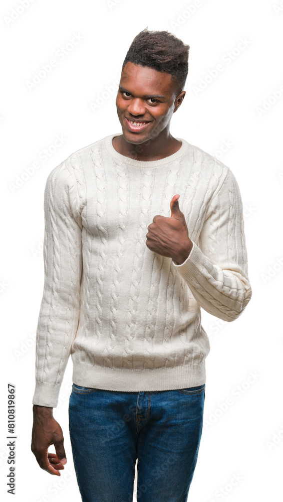 Wall mural Young african american man over isolated background doing happy thumbs up gesture with hand. Approving expression looking at the camera with showing success.