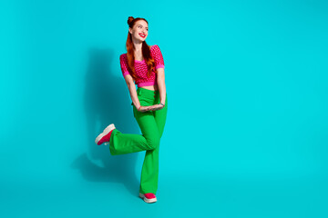 Full length photo of excited funky lady dressed pink knitted shirt looking emtpy space isolated blue color background