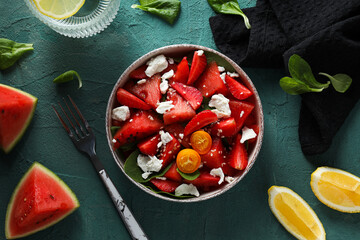 Watermelon salad in a bowl with a glass of water on a beautiful background