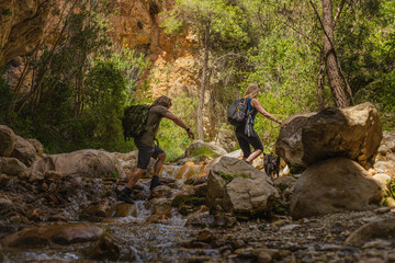 couple walking up a river during a hike in nature.jpg