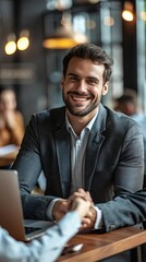 Smiling businessman shaking client hand