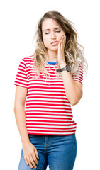 Fototapeta premium Beautiful young blonde woman over isolated background touching mouth with hand with painful expression because of toothache or dental illness on teeth. Dentist concept.
