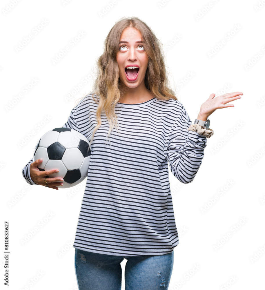 Poster beautiful young blonde woman holding soccer football ball over isolated background very happy and ex