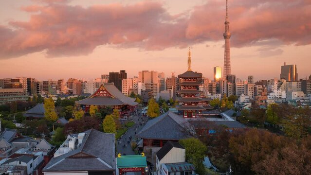 tokyo skyline time lapse day to night view of traditional temple with modern buildings and skytree tower in the background,timelapse starts at sunset