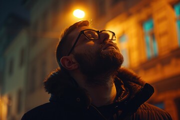Fototapeta premium A man with a beard and glasses standing in front of a building. Suitable for business and architecture concepts