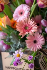 A vase filled with pink and yellow flowers. Perfect for home decor