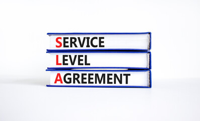 SLA service level agreement symbol. Concept words SLA service level agreement on beautiful books....