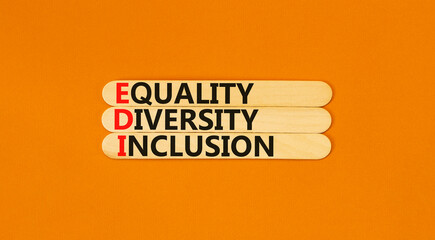 EDI equality diversity inclusion symbol. Concept words EDI equality diversity inclusion on wooden stick. Beautiful orange background. Business EDI equality diversity inclusion concept. Copy space.
