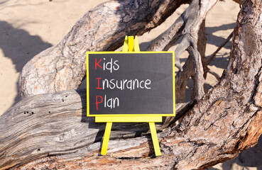 KIP kids insurance plan symbol. Concept words KIP kids insurance plan on beautiful yellow blackboard. Beautiful old tree background. Business KIP kids insurance plan concept. Copy space.