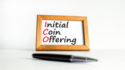 ICO initial coin offering symbol. Concept words ICO initial coin offering on beautiful wooden frame. Beautiful white background. Business ICO initial coin offering concept. Copy space.