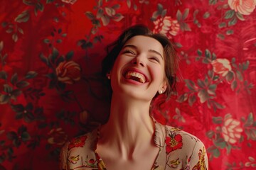 A woman smiling in front of a floral wallpaper, suitable for interior design projects