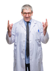 Handsome senior doctor, scientist professional man wearing white coat over isolated background shouting with crazy expression doing rock symbol with hands up. Music star. Heavy concept.