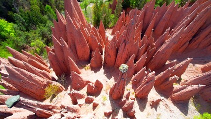 Upper Bolzano - Earth Pyramids - Aerial view from above vertically into the glowing pyramids on the mountainside