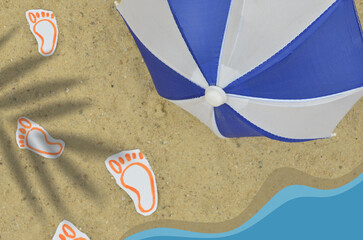 Summer beach: drawn footprints on the sand, graphics depicting an ocean and beach umbrella. Photo mixed with graphics. Top view, shallow depth of field.