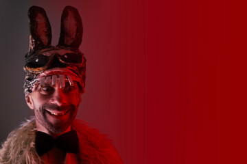 creepy man with smile, young guy in cringe in scary bunny mask, concept of Halloween party, theme...