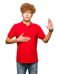 Young handsome man with afro hair wearing red t-shirt Swearing with hand on chest and open palm,...