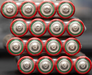 Close-up view of aa batteries stacked in symmetrical rows with vibrant red and green labels