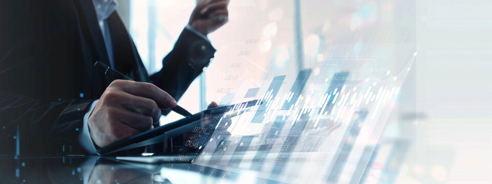 A man is writing on a tablet with a pen. Concept of productivity and focus, as the man is engaged in a task that requires concentration