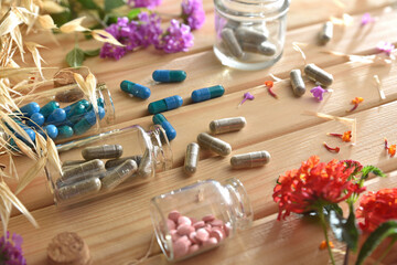Natural medicines from plants with capsules and pills in jars