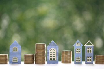 Mortgage,Model house and stack of coins money on natural green background,Business investment and...