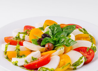 Fresh caprese salad with pesto sauce
