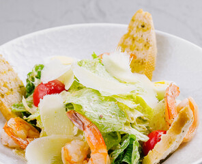 Fresh shrimp caesar salad with parmesan and croutons