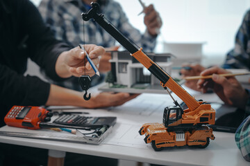 Team of engineers in a meeting, drawing blueprints for condo, apartment, and house construction....