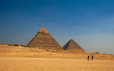Two lone travellers at the Great Pyramids of Giza