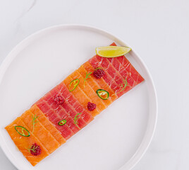 Fresh salmon carpaccio with citrus and chili