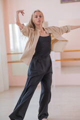 Caucasian woman dancing contemporary in ballet class. Rehearsal. Vertical photo.
