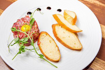 Beef tartare with egg and white bread croutons