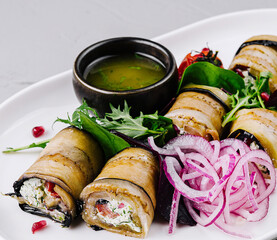 Gourmet eggplant rolls with fillings on elegant plate