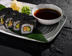 Exquisite black caviar sushi roll on elegant plate