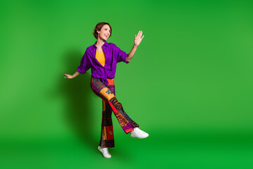 Photo portrait of funny young woman in purple stylish shirt pants and brown bob haircut dancing...