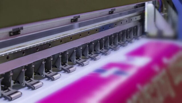 Large format inkjet printer printing with pink color on vinyl paper