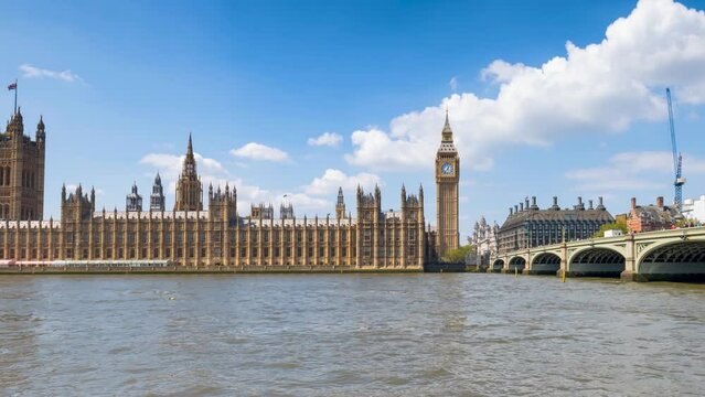 Panned time lapse view of the Westminster Palace and Big Ben clocktower in London, England, during a sunny summer day