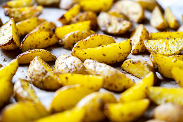 Potato wedges baked in the oven with spices , rustic potatoes at home.