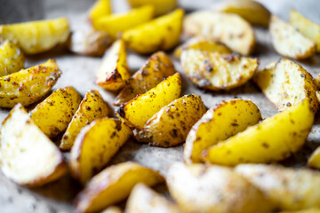 Potato wedges baked in the oven with spices , rustic potatoes at home.