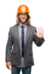 Young handsome architec man with long hair wearing safety helmet over isolated background showing and pointing up with fingers number five while smiling confident and happy.