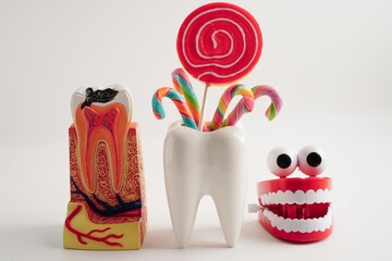 Tooth decay with sweet sugar candy, bad food for dental health care.