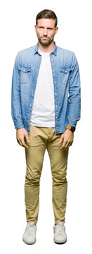 Handsome man with blue eyes and beard wearing denim jacket skeptic and nervous, frowning upset because of problem. Negative person.