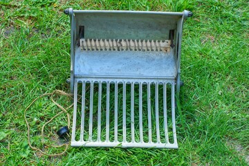 one retro electric old aluminum gray simple dangerous home open  heater with an electric cord...