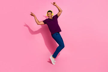 Full size photo of handsome young guy enjoy music dancing have fun wear trendy violet outfit isolated on pink color background