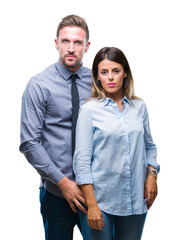 Young workers business couple over isolated background with serious expression on face. Simple and natural looking at the camera.